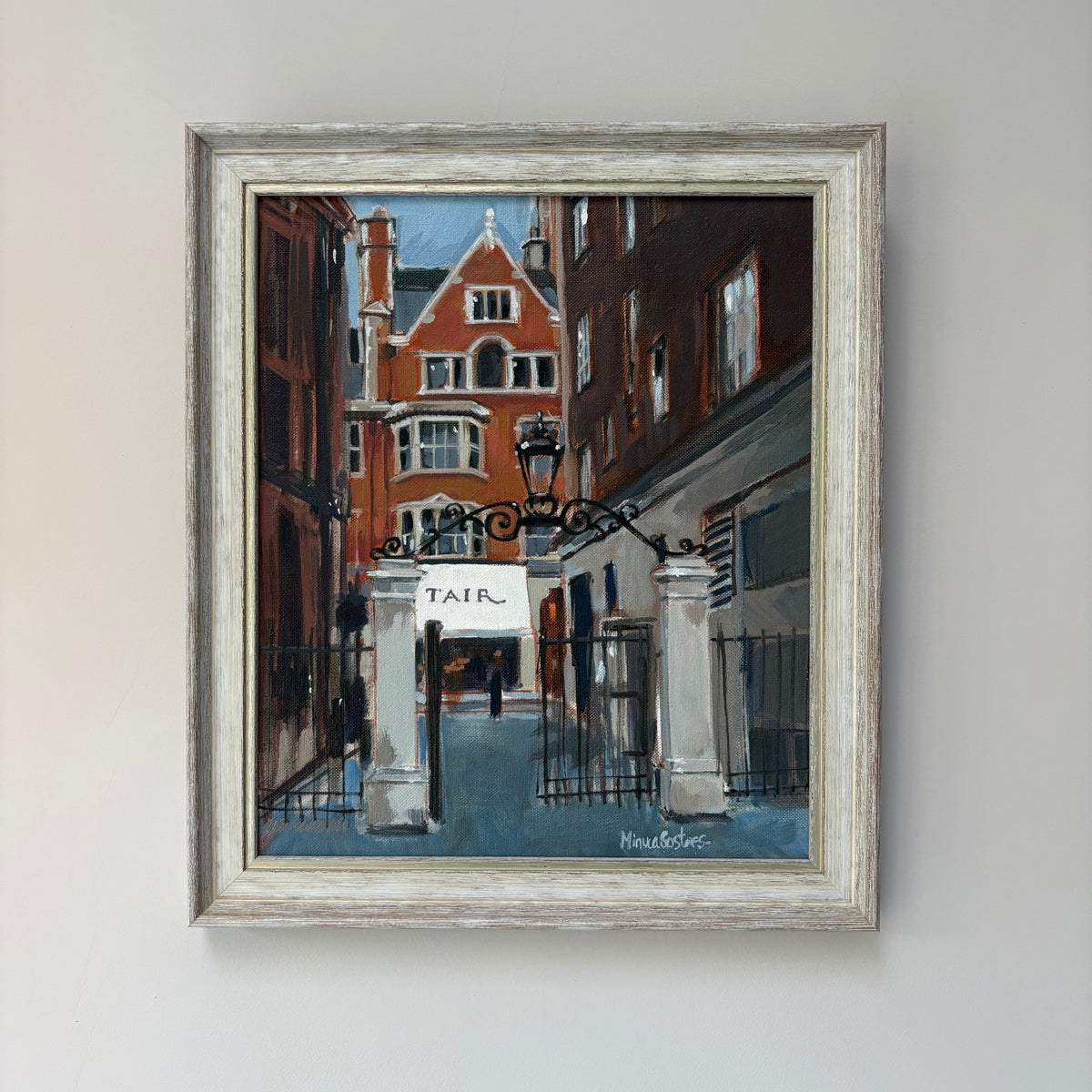 Framed oil painting of a street in Mayfair in London with a building architectural details.