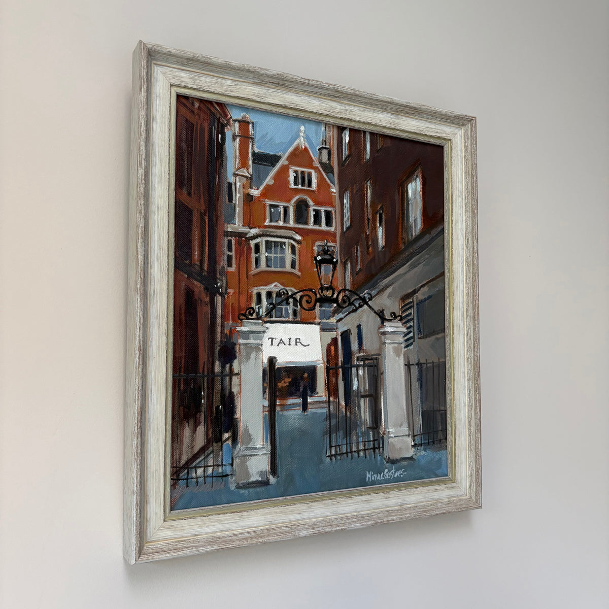 Framed oil painting of a street in Mayfair in London with a building architectural details.
