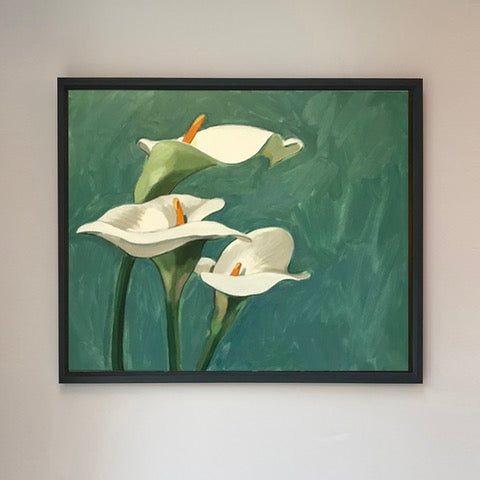 Framed artwork of white lilies on a green background