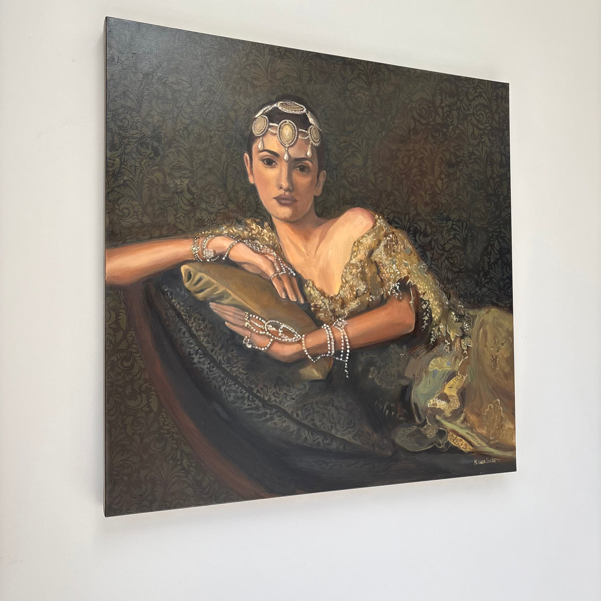 Portrait of a woman in elaborate clothing and jewelry against a dark background